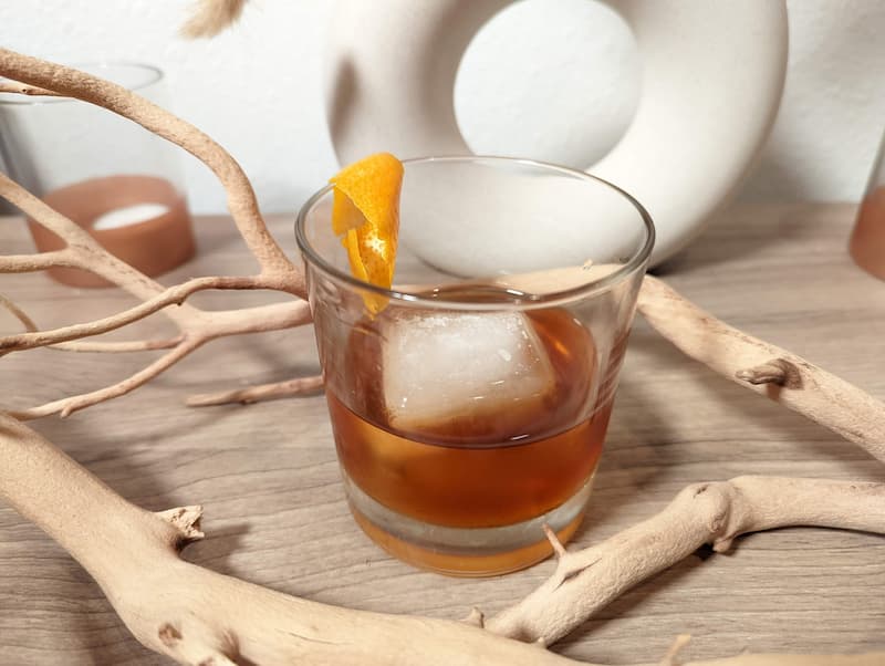 Old fashioned cocktail in a whiskey glass garnished with an orange peel