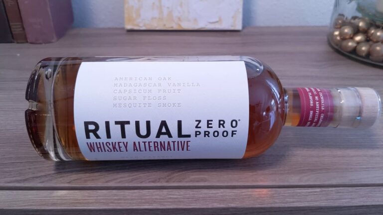 Bottle of Ritual Zero Proof whiskey alternative laying on its side